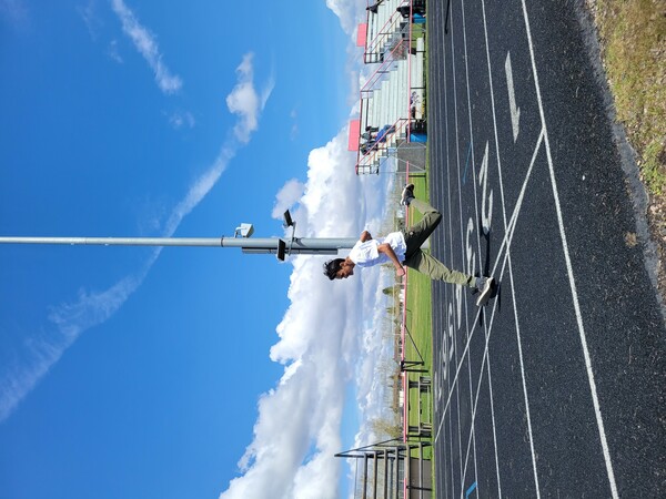 a photo of a male runner crossing the finish line