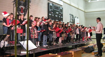 students on risers singing at Christmas